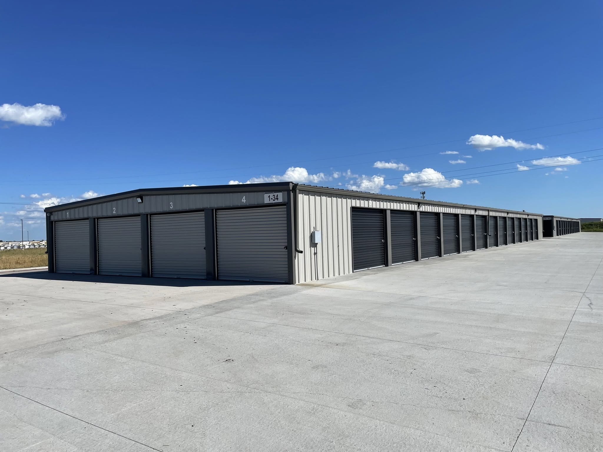 Drive Up Storage Building that is gray and black doors